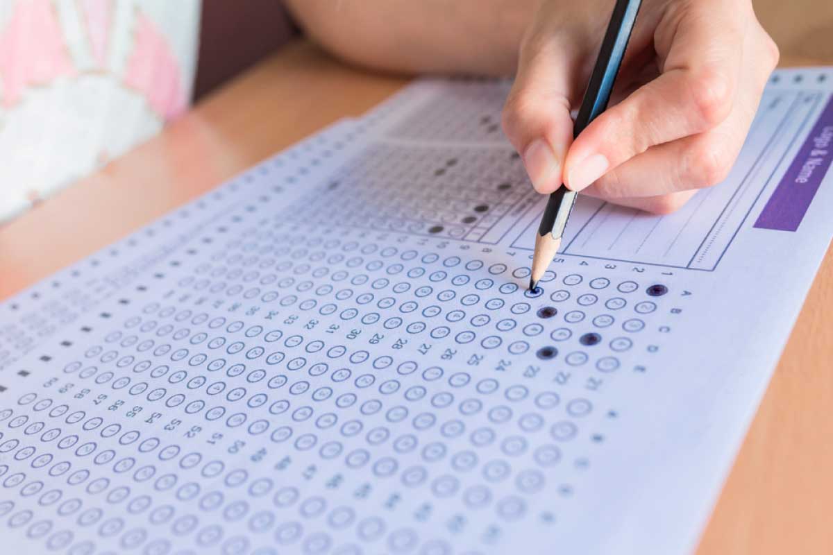 Estudiante resolviendo una prueba, marcando en la hoja de respuestas llenando los círculos con un lapiz